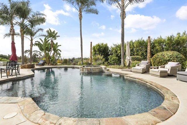 view of pool with a patio and an in ground hot tub