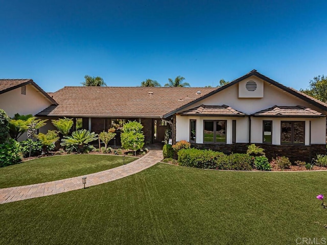 ranch-style house featuring a front lawn