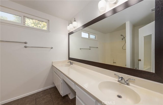 bathroom featuring walk in shower, vanity, and tile patterned flooring