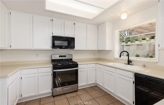 kitchen featuring white cabinetry, sink, light tile patterned floors, and black appliances