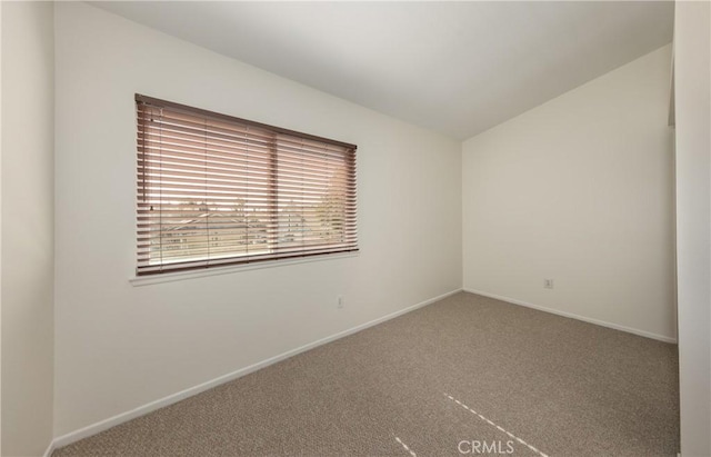 empty room with lofted ceiling and carpet floors