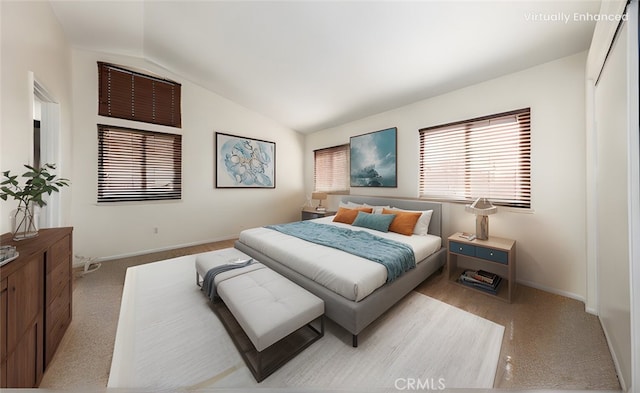 carpeted bedroom with lofted ceiling