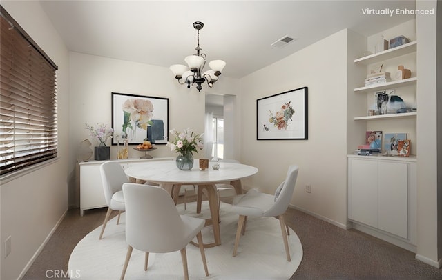 dining room with a wealth of natural light, light colored carpet, and a chandelier