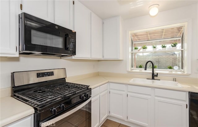 kitchen featuring stainless steel range with gas cooktop, sink, and white cabinets