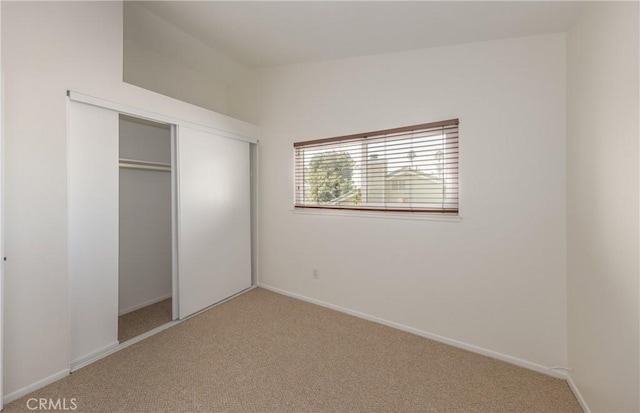 unfurnished bedroom with carpet floors and a closet