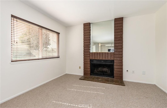 unfurnished living room featuring carpet and a fireplace