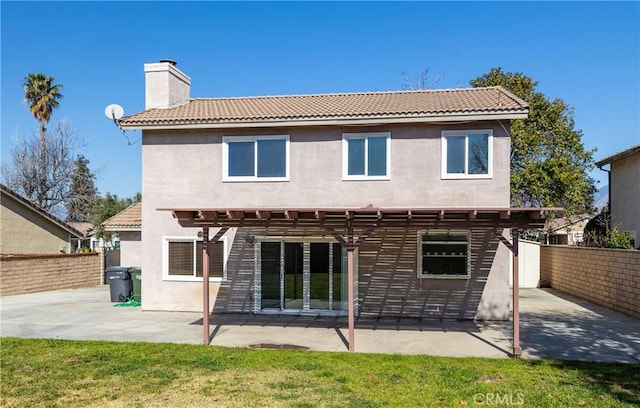 back of property featuring a yard, a pergola, and a patio area