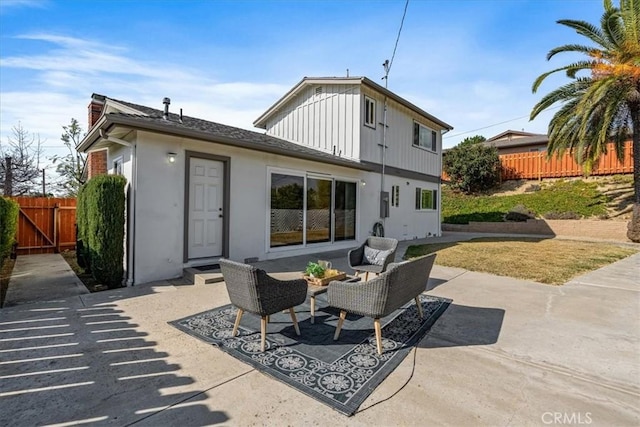 rear view of property featuring a patio and an outdoor hangout area