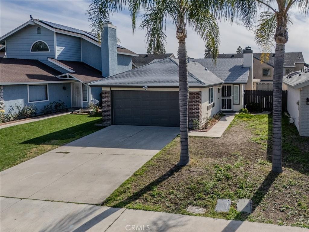 view of front of home with a garage and a front lawn