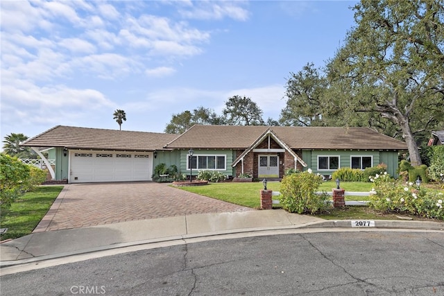 ranch-style home with a garage and a front yard