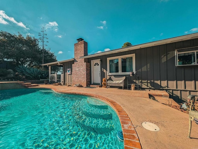 view of swimming pool with a patio