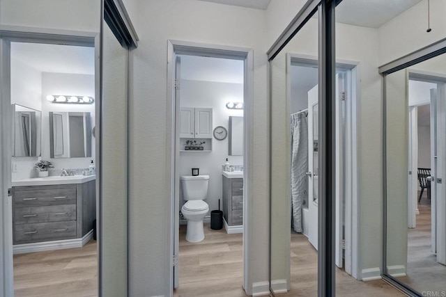 bathroom featuring vanity, hardwood / wood-style flooring, and toilet