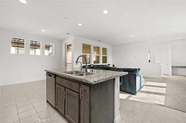 kitchen featuring recessed lighting, stainless steel dishwasher, open floor plan, a sink, and an island with sink