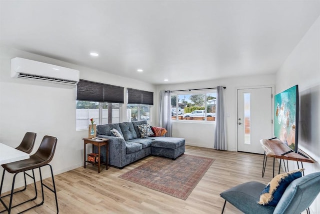 living room with light hardwood / wood-style flooring and a wall mounted AC