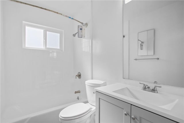 full bathroom featuring vanity, washtub / shower combination, and toilet