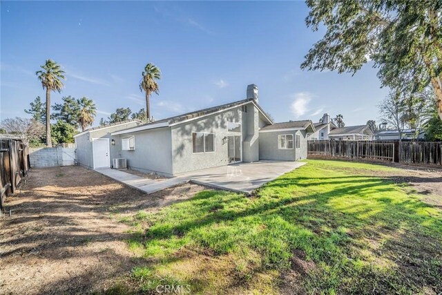 rear view of property featuring a yard and a patio