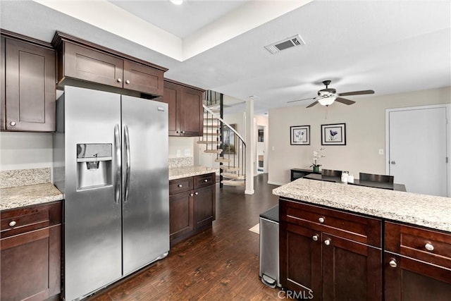 kitchen featuring dark brown cabinets, dark wood-type flooring, light stone counters, and stainless steel fridge with ice dispenser