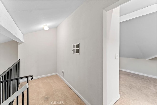 interior space featuring vaulted ceiling and light colored carpet