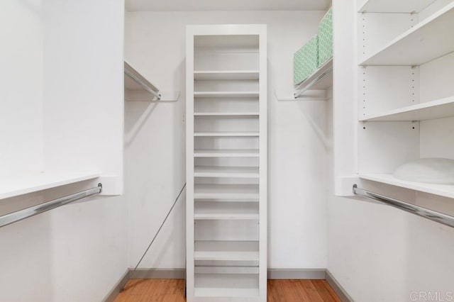 spacious closet featuring light hardwood / wood-style flooring