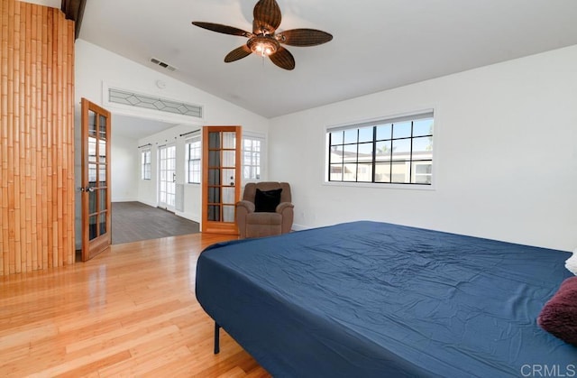 bedroom with french doors, ceiling fan, vaulted ceiling, and hardwood / wood-style floors