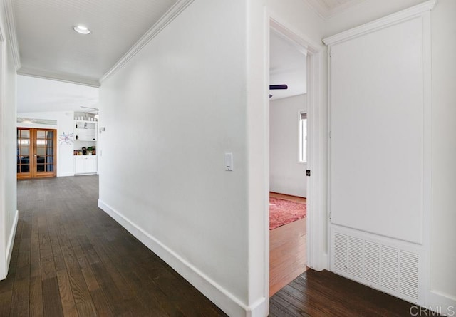 hall with dark hardwood / wood-style flooring and ornamental molding