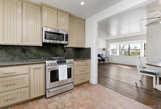 kitchen with tasteful backsplash, ceiling fan, and stainless steel appliances