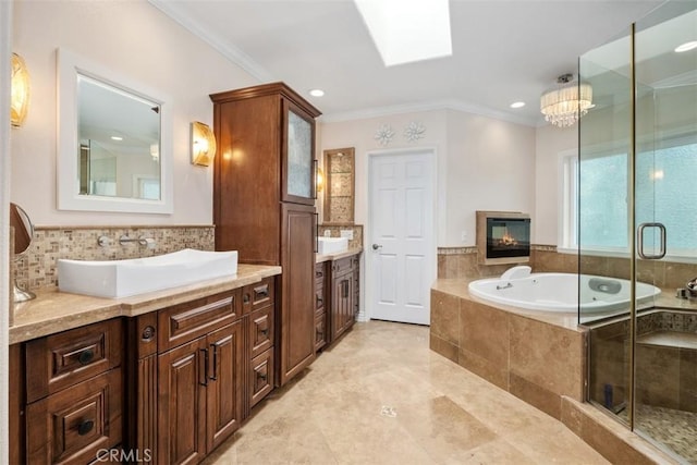 bathroom featuring a skylight, crown molding, vanity, and plus walk in shower