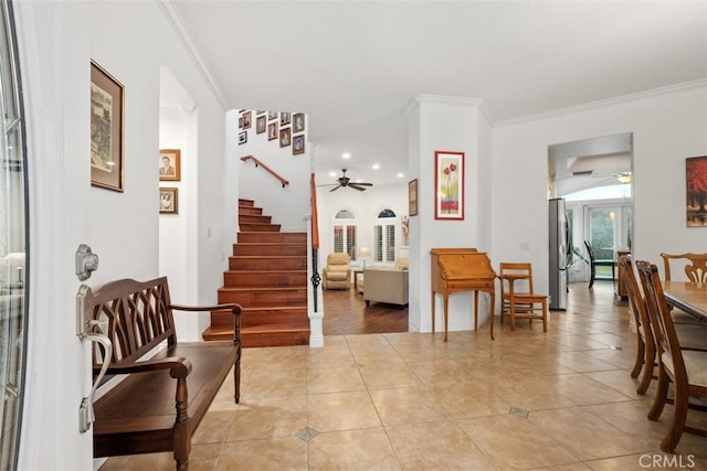 interior space with ornamental molding and ceiling fan