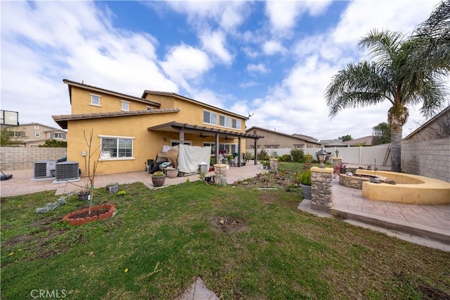 back of property featuring central AC unit, a patio, and a lawn