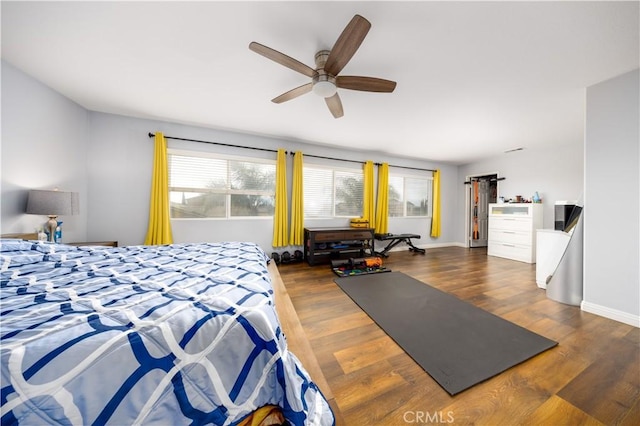 bedroom featuring dark wood-type flooring and multiple windows