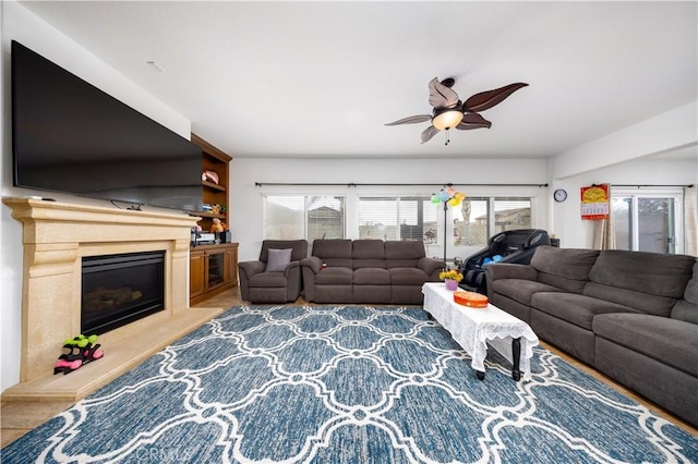 living room featuring ceiling fan and plenty of natural light