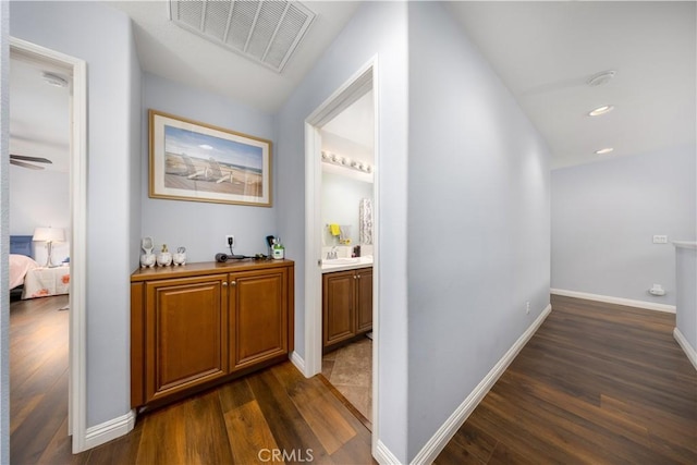 hall with dark hardwood / wood-style floors and sink