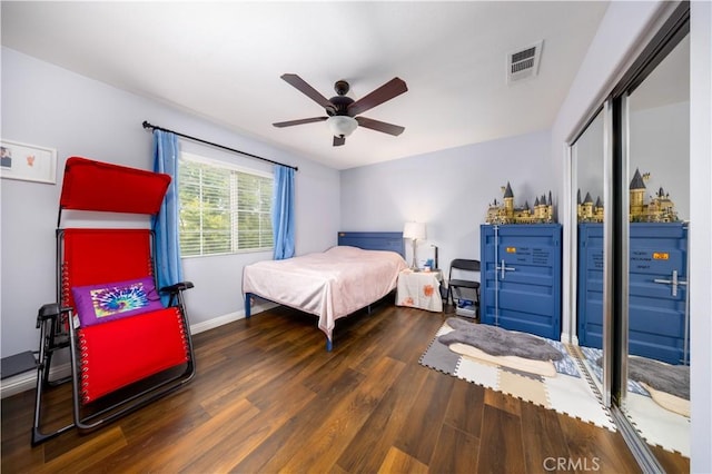 bedroom featuring dark hardwood / wood-style flooring, a closet, and ceiling fan