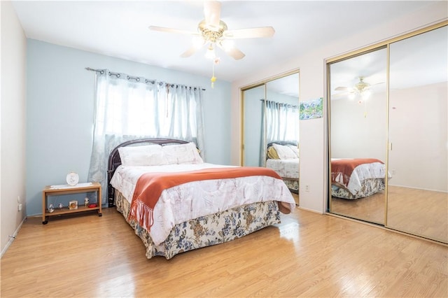 bedroom featuring multiple closets, light wood finished floors, and a ceiling fan