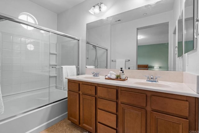 bathroom with tile patterned floors, bath / shower combo with glass door, and vanity