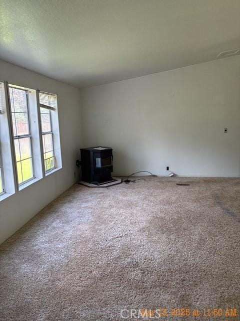 1845 Spring Valley Rd, Clearlake Oaks, CA 95423 - carpeted empty room with a wood stove