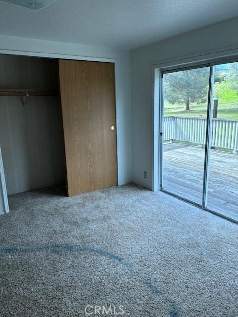 1845 Spring Valley Rd, Clearlake Oaks, CA 95423 - unfurnished bedroom with access to outside, carpet flooring, and a closet