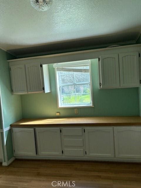 1845 Spring Valley Rd, Clearlake Oaks, CA 95423 - kitchen with dark wood-style flooring, light countertops, a textured ceiling, and white cabinetry