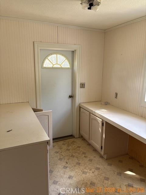 1845 Spring Valley Rd, Clearlake Oaks, CA 95423 - laundry room featuring crown molding and light floors