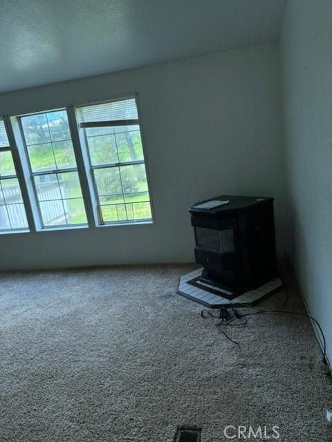 1845 Spring Valley Rd, Clearlake Oaks, CA 95423 - unfurnished room with a wood stove and carpet