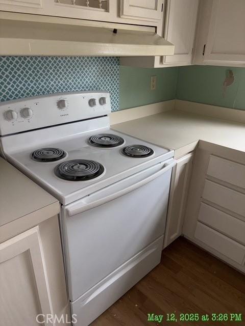 1845 Spring Valley Rd, Clearlake Oaks, CA 95423 - kitchen featuring white electric stove, dark wood-style flooring, light countertops, and under cabinet range hood