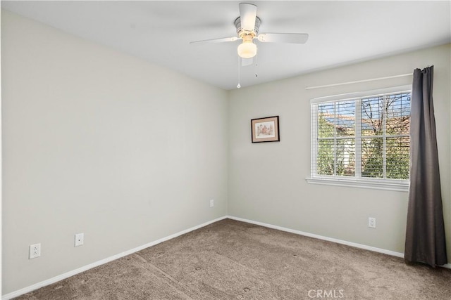 spare room featuring carpet flooring and ceiling fan