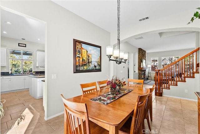 dining space featuring light tile patterned floors and an inviting chandelier