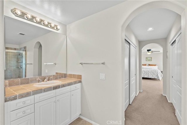 bathroom featuring ceiling fan and vanity