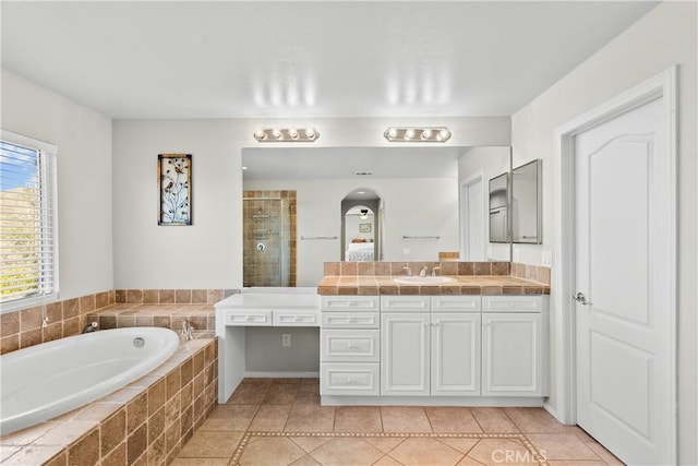 bathroom with vanity, tile patterned flooring, and shower with separate bathtub