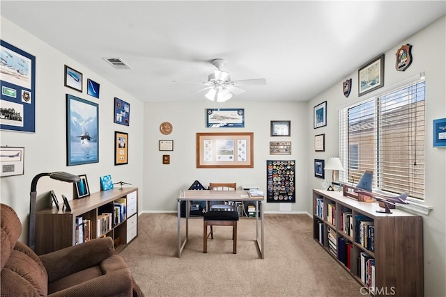 carpeted office with ceiling fan