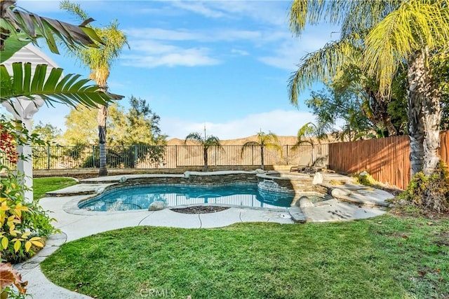 view of pool with a lawn