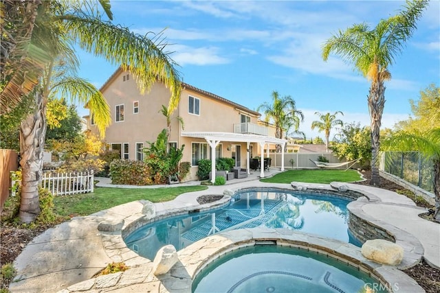 view of swimming pool featuring a patio, a yard, a pergola, and an in ground hot tub