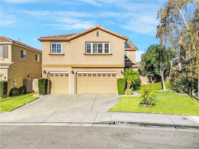 mediterranean / spanish-style home with a front yard and a garage