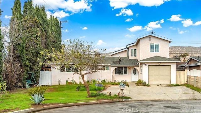 front of property with a garage and a front yard